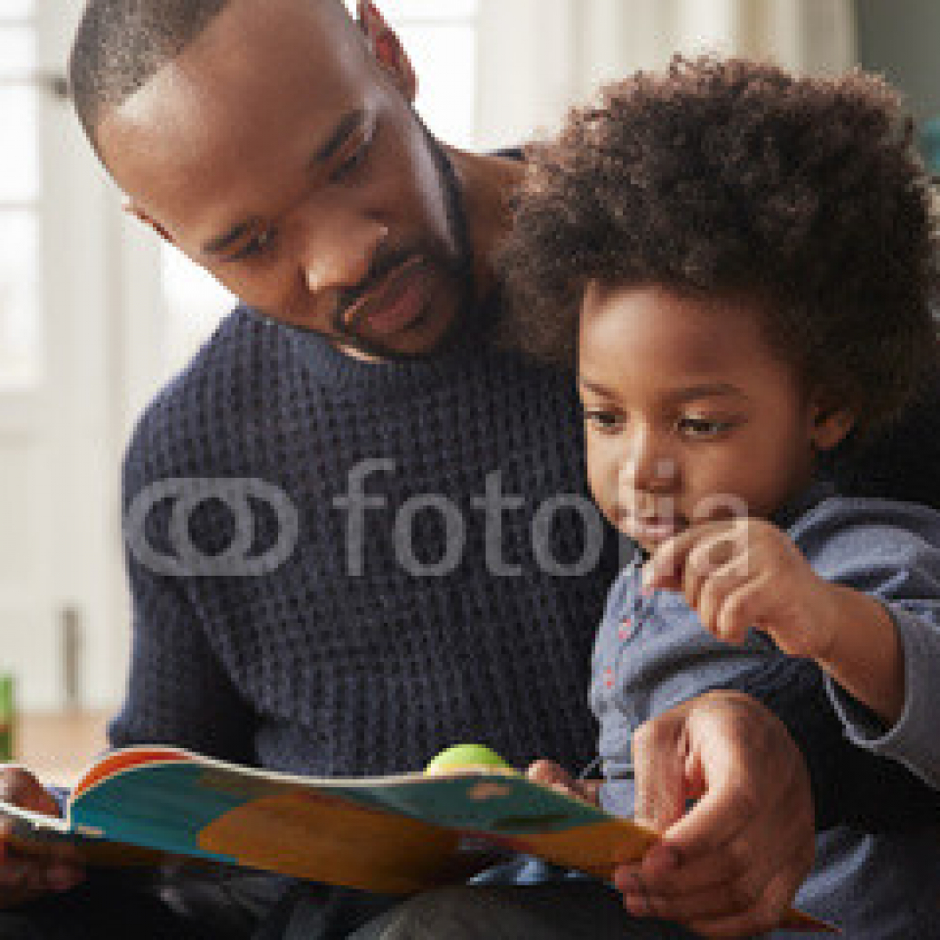 Father-And-Young-Son-Reading-Book-Together-At-Home.jpg