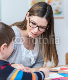 Kindergarten-Teacher-Supports-Child-on-Class.jpg